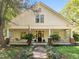 Inviting home featuring a large front porch with swing, lush landscaping, and beautiful curb appeal at 109 N Hassel St, Hillsborough, NC 27278