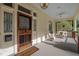 Charming front porch with cozy seating, decorative details, and a unique front door at 109 N Hassel St, Hillsborough, NC 27278