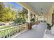 Spacious front porch with columns, ceiling fans, and a swing for relaxing at 109 N Hassel St, Hillsborough, NC 27278