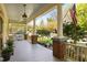 Spacious front porch featuring classic columns and a comfortable seating area with a porch swing at 109 N Hassel St, Hillsborough, NC 27278