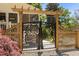 Close up of ornate metal entry gate with a wooden pergola at 109 N Hassel St, Hillsborough, NC 27278