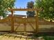 Wooden gate surrounded by pergola with an arched top and lattice at 109 N Hassel St, Hillsborough, NC 27278
