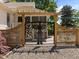 Ornate metal entry gate with a wooden pergola provides stylish access to the property at 109 N Hassel St, Hillsborough, NC 27278