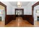 Spacious hallway with hardwood floors, wood paneling, and detailed trim throughout at 109 N Hassel St, Hillsborough, NC 27278