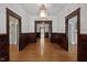 Hallway features hardwood floors, detailed wood paneling, and classic architectural details at 109 N Hassel St, Hillsborough, NC 27278