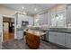 Well-equipped kitchen with stone countertops, gray cabinets, stainless steel appliances, and wood island at 109 N Hassel St, Hillsborough, NC 27278