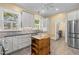 Bright kitchen with stainless steel appliances, gray cabinets, and butcher block island at 109 N Hassel St, Hillsborough, NC 27278