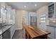 Modern kitchen features white cabinets, stainless steel appliances and wood top island at 109 N Hassel St, Hillsborough, NC 27278