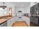 A lovely kitchen with white cabinets, wood counters, subway tile, and stainless steel refrigerator at 109 N Hassel St, Hillsborough, NC 27278