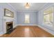 Cozy living room with hardwood floors, fireplace, and abundant natural light at 109 N Hassel St, Hillsborough, NC 27278