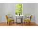Close up of living room seating next to windows looking out to trees at 109 N Hassel St, Hillsborough, NC 27278