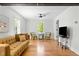 Bright living room with hardwood floors, comfortable seating, and plenty of natural light at 109 N Hassel St, Hillsborough, NC 27278