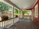 Covered porch with wooden flooring offering a charming outdoor living space at 109 N Hassel St, Hillsborough, NC 27278