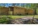 Expansive backyard view shows brick exterior, balcony, patio, and green lawn at 110 Omega Rd, Henderson, NC 27536