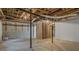 Unfinished basement featuring concrete floor, exposed ceiling and support beams awaiting customization at 110 Omega Rd, Henderson, NC 27536