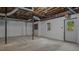 Spacious unfinished basement with concrete floors, a window, and an exterior door for easy access at 110 Omega Rd, Henderson, NC 27536