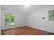 This bedroom provides hardwood floors and large windows for natural light at 110 Omega Rd, Henderson, NC 27536