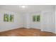 Bright bedroom with hardwood floors, large windows, and ample closet space at 110 Omega Rd, Henderson, NC 27536