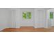 Sunlit bedroom with hardwood floors, window and large closet space at 110 Omega Rd, Henderson, NC 27536