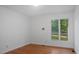 This bedroom offers wood floors and a large window to bring in natural light at 110 Omega Rd, Henderson, NC 27536