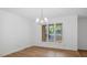 Dining room boasts hardwood floors and large window providing natural light and neighborhood views at 110 Omega Rd, Henderson, NC 27536