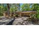 Brick home with an open garage and mature landscaping at 110 Omega Rd, Henderson, NC 27536