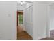Hallway with wood-look flooring, closet with bi-fold doors, and view of the backyard at 110 Omega Rd, Henderson, NC 27536