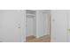 Bright hallway features a closet with bi-fold doors, wood-look flooring, and white trim at 110 Omega Rd, Henderson, NC 27536