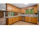 Cozy kitchen featuring stainless appliances, wood cabinetry, and ample counter space at 110 Omega Rd, Henderson, NC 27536