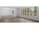 Spacious living room featuring bright white walls, large windows, and modern flooring at 110 Omega Rd, Henderson, NC 27536