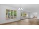 Bright living room with large windows offering scenic outdoor views, modern flooring, and updated lighting at 110 Omega Rd, Henderson, NC 27536