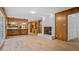 Open-concept living area with wood paneling, painted brick fireplace, and modern floors at 110 Omega Rd, Henderson, NC 27536