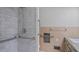 Walk-in shower features marble tiling, chrome shower head, and chrome hand rails at 110 Omega Rd, Henderson, NC 27536