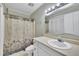 This bathroom offers a functional vanity, a shower with a decorative curtain, and ample lighting at 121 Drumbuie Pl, Garner, NC 27529