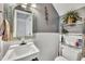This charming bathroom features beadboard paneling, a stylish mirror, and a convenient storage shelf above the toilet at 121 Drumbuie Pl, Garner, NC 27529