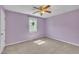 An inviting bedroom with soft purple walls, neutral carpet, and a ceiling fan providing comfort at 121 Drumbuie Pl, Garner, NC 27529