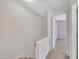 Hallway view showing access to the stairwell and a purple-walled room at the end of the hall at 121 Drumbuie Pl, Garner, NC 27529