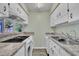 Bright kitchen offering white cabinets, granite countertops, and modern appliances at 121 Drumbuie Pl, Garner, NC 27529