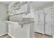 Bright kitchen with white cabinets, granite countertops and breakfast bar at 121 Drumbuie Pl, Garner, NC 27529