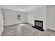 Spacious living room with fireplace, sleek flooring, and lots of natural light at 121 Drumbuie Pl, Garner, NC 27529