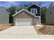 New construction home featuring a brick accent over the garage and a two-car driveway at 130 N Keatts Winner Ct, Wilson's Mills, NC 27520