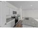 Close up of a sleek, modern kitchen with stainless steel appliances and granite countertops at 130 N Keatts Winner Ct, Wilson's Mills, NC 27520