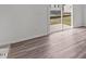 Living room with hardwood floors and glass sliding door leading to the exterior at 130 N Keatts Winner Ct, Wilson's Mills, NC 27520