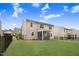 Rear exterior view featuring a well-maintained backyard, screened porch, and full fence at 130 Stromness Path, Clayton, NC 27527