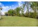 Large backyard with a play set, mature trees, and a spacious lawn at 130 Stromness Path, Clayton, NC 27527