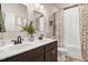 Bathroom featuring double sinks, decorative mirrors, and neutral tones at 130 Stromness Path, Clayton, NC 27527