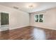 An empty bedroom featuring hard wood floors, a window and neutral colored walls at 130 Stromness Path, Clayton, NC 27527