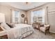 Bright bedroom with neutral decor, large windows, and cozy seating at 130 Stromness Path, Clayton, NC 27527