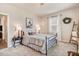 Bedroom showcasing bed, side table and chair with neutral colored walls at 130 Stromness Path, Clayton, NC 27527