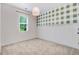 Well-lit bedroom with light green plaid wall, carpet, and a modern ceiling light at 130 Stromness Path, Clayton, NC 27527